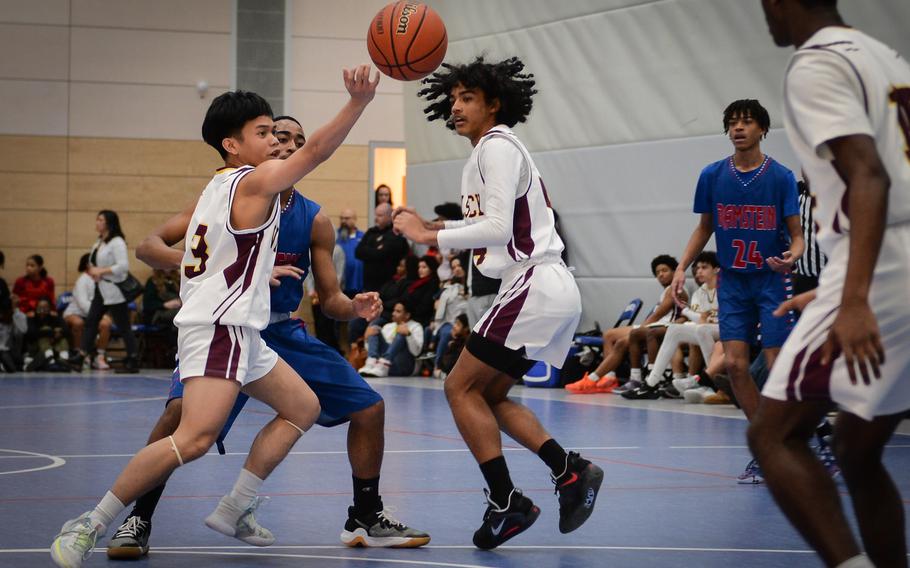 Vilseck's CJ Andrade scrums with Ramstein's Ky'ron Hall for possession of the ball during the DODEA European Division I boys basketball championships at Ramstein Air Base in Germany on Feb. 16, 2023.