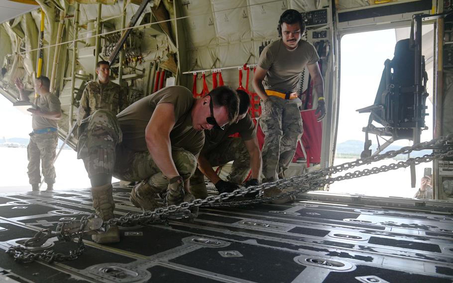 The 8th Expeditionary Air Mobility Squadron team from Al Udeid Air Base, Qatar, tie down a Humvee after loading it onto a C-130 Hercules airplane during the Port Dawg Rodeo at Ramstein Air Base, Germany, July 6, 2022.