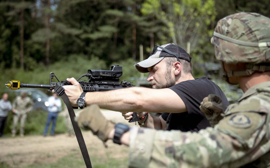 A man holds a firearm.