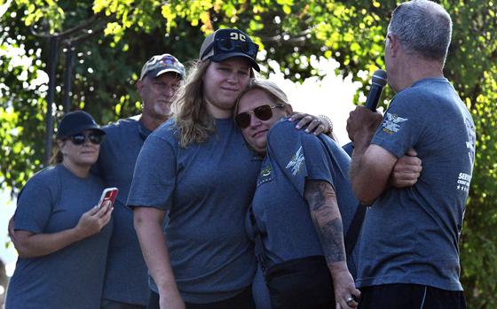 Gwendolyn Sanders, the widow of Staff Sgt. Charles "Chuck" Sanders, embraces Mikayla Degel at a memorial ceremony at Katterbach Kaserne in Germany on July 18, 2025. The ceremony commemorated 20 years since the crash of an Army CH-47 Chinook helicopter in Afghanistan killed all 18 people aboard, including Sanders' husband. 