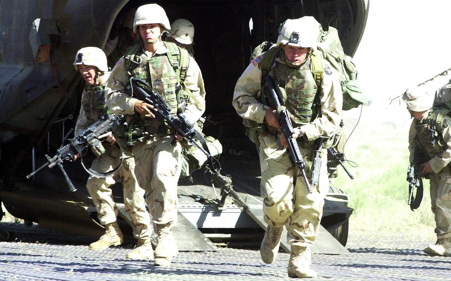 Troops from the 101st Airborne Division in Afghanistan rehearse combat drills at Bagram Airfield in May 2002. 