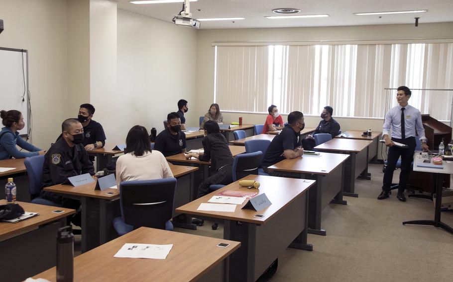 Naoya Yonamine, a management analyst with the 718th Force Support Squadron, teaches a "continuous process improvement" course to Japanese workers at Kadena Air Base, Okinawa, March 15, 2022.