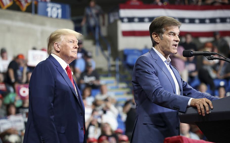 Former President Donald Trump listens as Pennsylvania GOP Senate candidate Dr. Mehmet Oz speaks at a rally in Wilkes-Barre, Pa., on Sept. 3, 2022. According to reports on Friday, Nov. 4, Trump is tentatively planning to announce his intention to run for president in 2024.