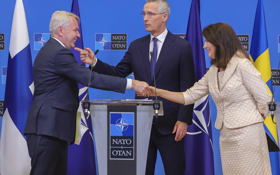 Finland’s Foreign Minister Pekka Haavisto, left, Sweden’s Foreign Minister Ann Linde, right, and NATO Secretary General Jens Stoltenberg attend a media conference after the signature of the NATO Accession Protocols for Finland and Sweden in the NATO headquarters in Brussels, July 5, 2022. 