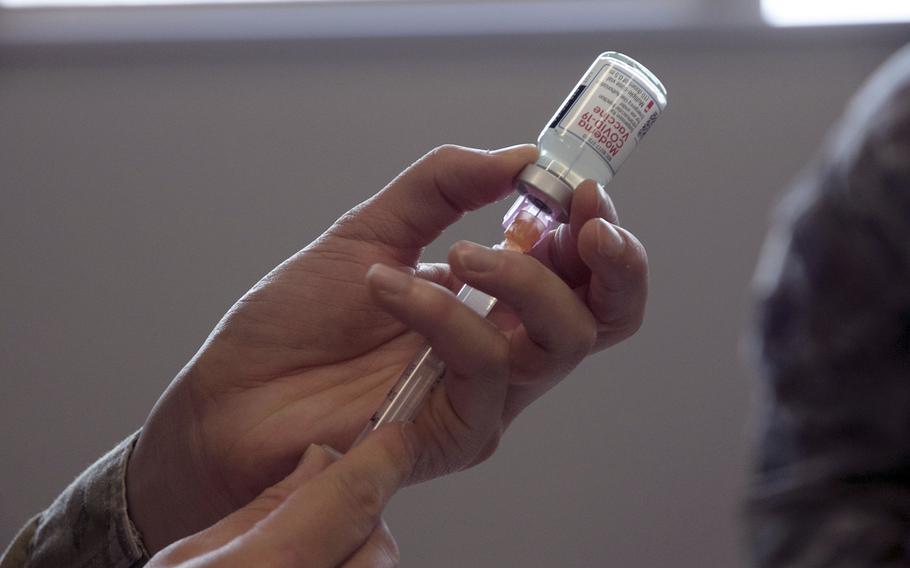 An airman loads a syringe with Moderna’s COVID-19 vaccine in December 2020 at Kadena Air Base, Okinawa.