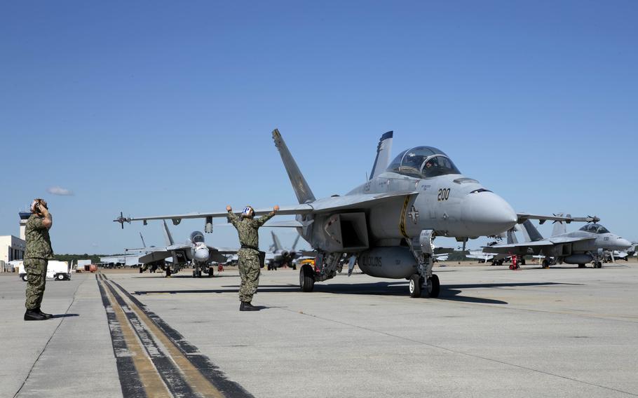 Rear Adm. Gregory Huffman, commander, carrier strike group (CSG) 12, taxis an FA-18E Super Hornet on the runway of Naval Air Station Oceana during an airborne change of command ceremony for Carrier Air Wing (CVW) 8, Sept. 30, 2021. Huffman was the senior officer in attendance at the ceremony where Capt. Joshua A. Sager was relieved by Capt. Dary E. Trent as Commander, CVW-8, during a ceremony attended by family, friends and staff.