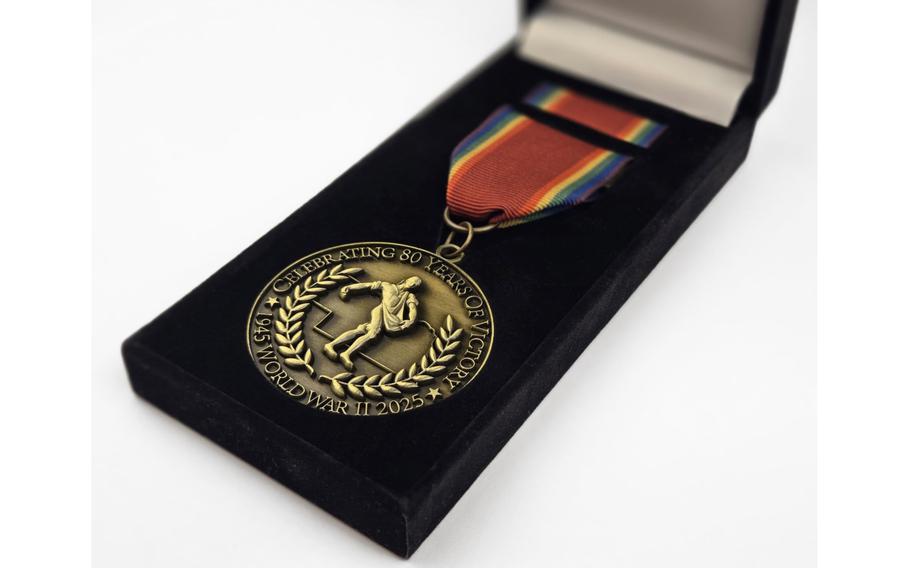 A medal is seen in a velvet box.