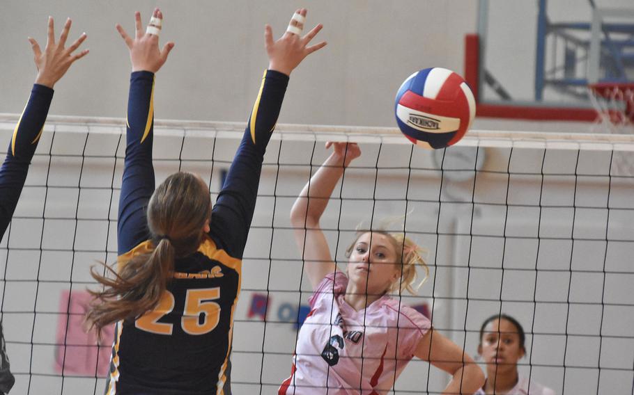 Aviano's Kayla Graney watches her kill sail past the attempted block of Ansbach's Kennedy Kohrs on Saturday, Oct. 15, 2022. The two previously unbeaten teams split a pair of matches.