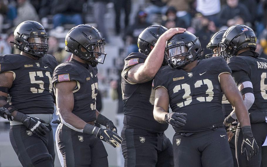 Army running back Jakobi Buchanan celebrates with teammates after scoring a touchdown against Massachusetts in the fourth quarter of an NCAA college football game, Saturday, Nov. 20, 2021, in West Point, N.Y.