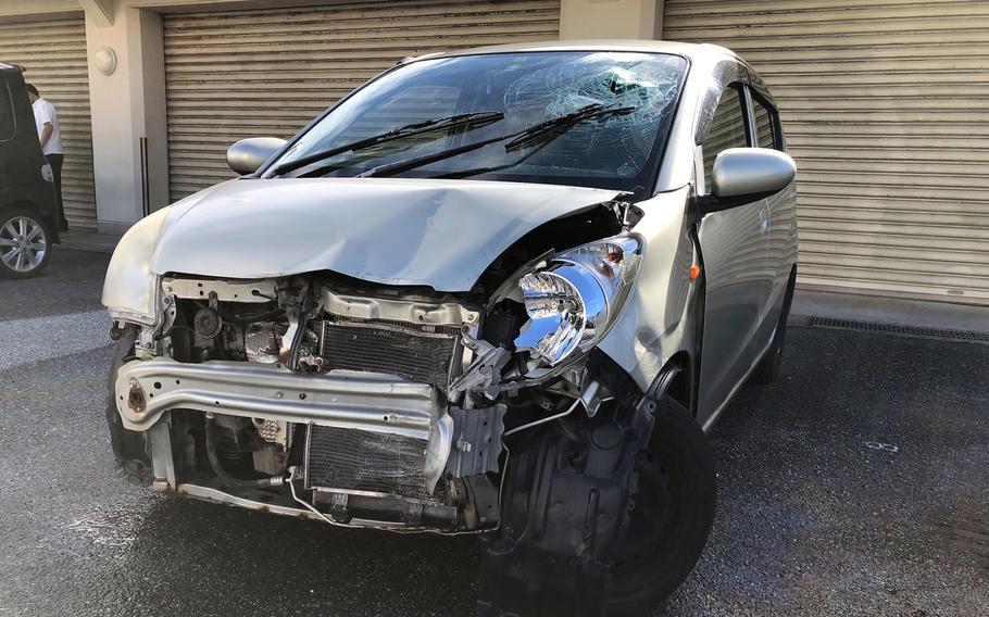 Marine Cpl. Christian Alvareztoc's Daihatsu Mira sits damaged at the Naha Police Station on Okinawa, Monday, Nov. 28, 2022. 