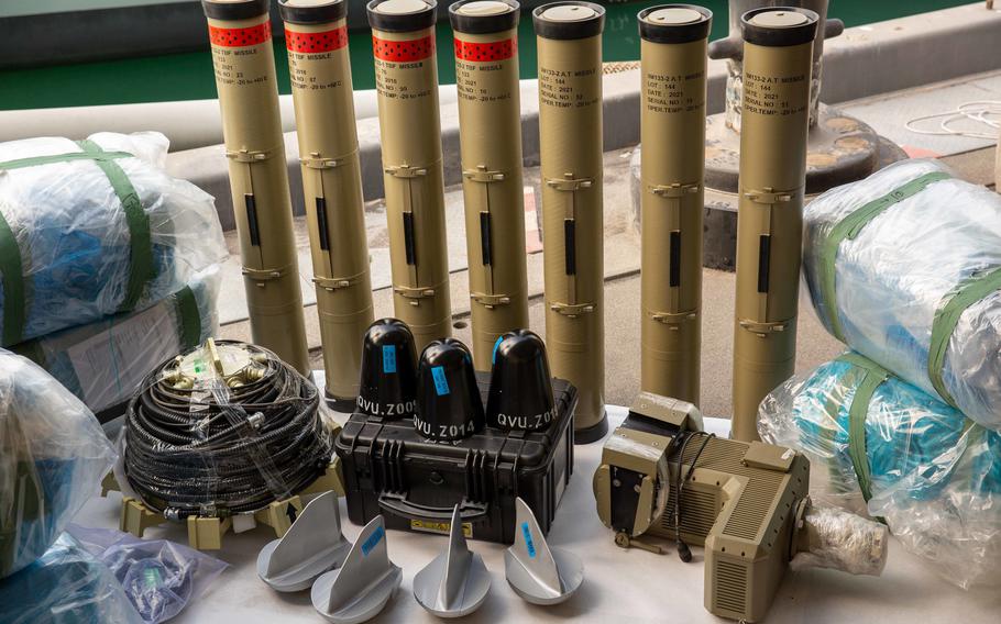 Anti-tank guided missiles and medium-range ballistic missile components seized by the British navy sit pierside at an unnamed military site in the U.S. 5th Fleet area of operations, Feb. 26, 2023. The weapons were seized on a ship coming from Iran in the Gulf of Oman, the U.S. Navy said.