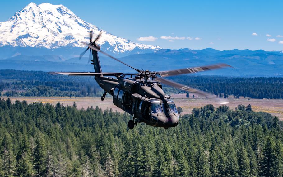 A UH-60 helicopter assigned to Bravo “Bigfoot” Company, 2-158 Assault Helicopter Battalion, 16th Combat Aviation Brigade, conducts a reenlistment flight to Whidbey Island, Wash., on Jun. 17, 2021.