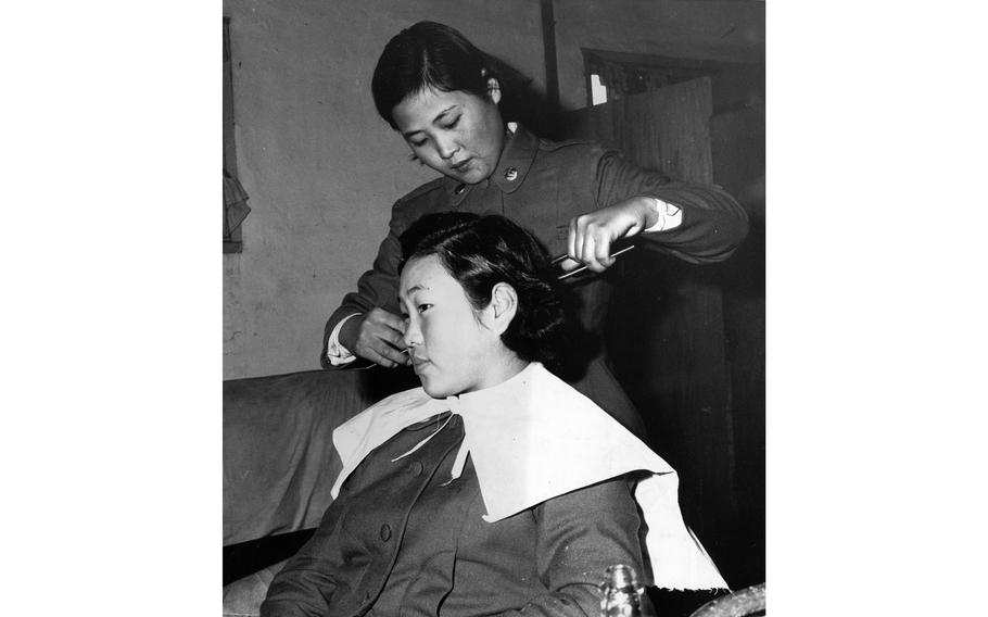 A young Republic of Korea Women’s Army Corps trainee gets her hair cut by a fellow student at the WAC Training Center in Seoul. The beauty parlor takes care of the girls during their off-duty hours when they are not training.