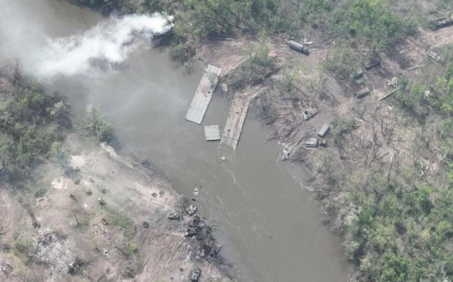 Ukrainian aerial photographs of the May 11, 2022, attack on a Russian army unit shows blown-up tanks and other combat vehicles on both sides of the Siversky Donets River and a pontoon bridge under water. 