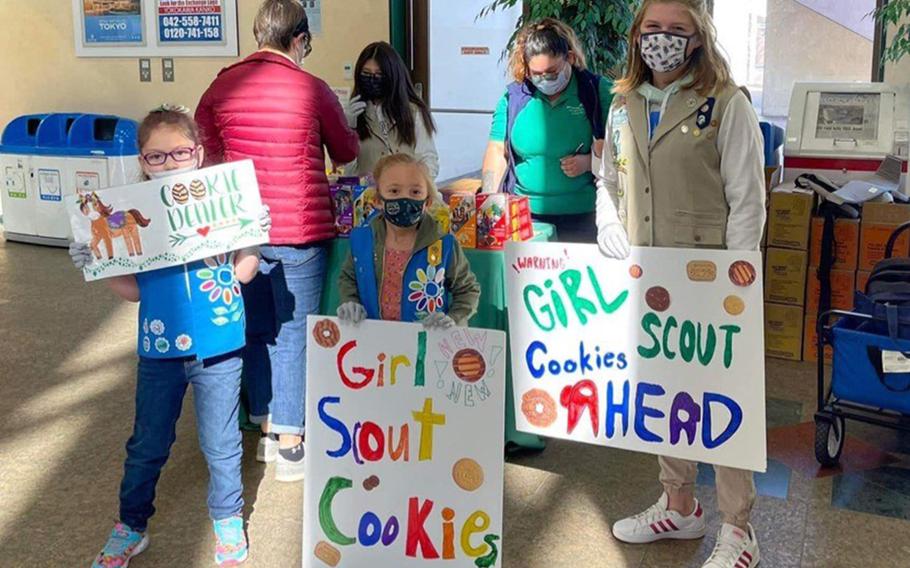 Girl Scouts work to drum up business while selling cookies at Yokota Air Base, Japan, Feb. 5, 2022. 