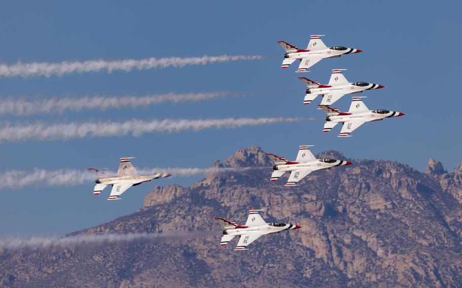 Aircraft fly in formation over mountains