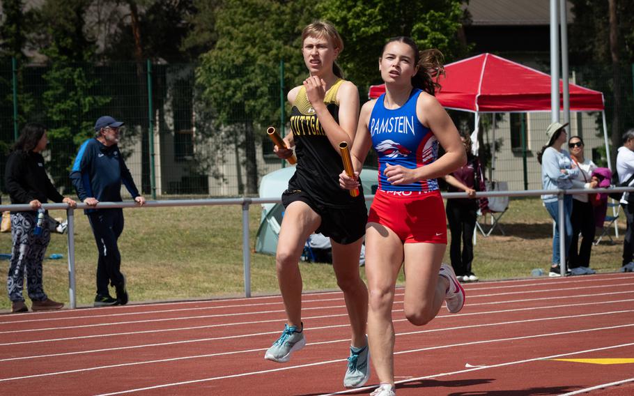 Stuttgart’s Anna Konon and Ramstein’s Iliana Echard battle for the lead during the second leg of the girls’ 3,200-meter relay at the DODEA Europe track and field championships on Thursday, May 22, 2025, in Kaiserslautern, Germany. Stuttgart went on to the win the event in 9:57.91, about three seconds faster than Ramstein. Kendall Cancel, Pasha Miletich and Lydia Pound were the other runners for Stuttgart.