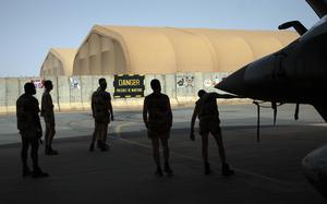 FILE - French Barkhane Air Force mechanics maintain a Mirage 2000 on the Niamey, Niger base on June 5, 2021. President Emmanuel Macron says France will end its military presence in Niger and pull its ambassador out of the country after its democratically elected president was deposed in a coup. France has maintained some 1,500 troops in Niger since the July coup and refused an order by the new junta for its ambassador to leave. (AP Photo/Jerome Delay, File)