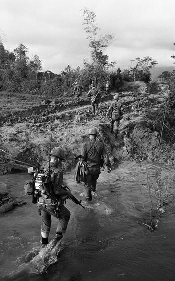 Soldiers walk in a line.