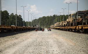 U.S. Army Soldiers assigned to 2nd Brigade Combat Team, 10th Mountain Division (LI), remove equipment from the railroad tracks with a utility vehicle in preparation for rotation at the Joint Readiness Training Center (JRTC) on Fort Polk, Louisiana, Aug. 6, 2025. JRTC is designed to improve unit readiness through force-on-force exercises that prepare Soldiers for missions they may be assigned in real-world operations. (U.S. Army photo by Spc. Mariah Aguilar)