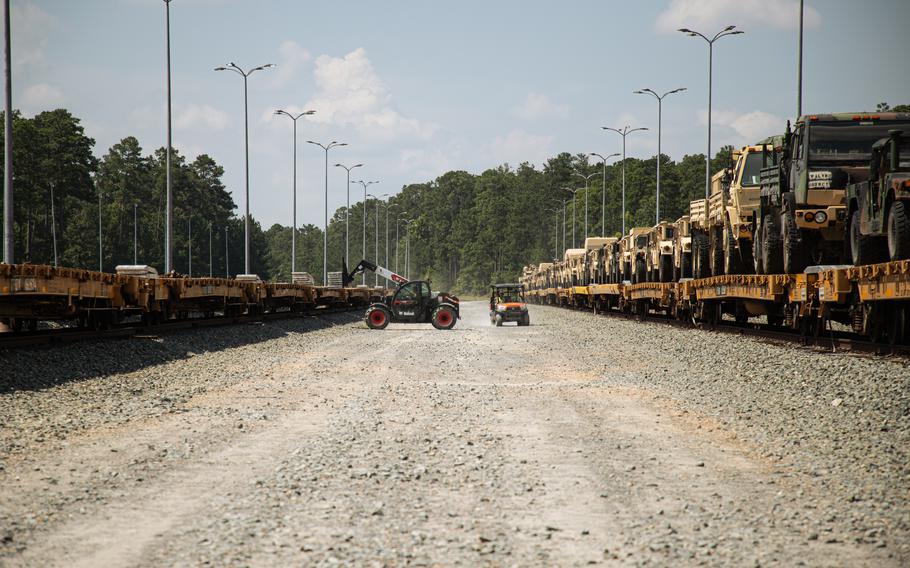 Soldiers taking equipment off of trains.