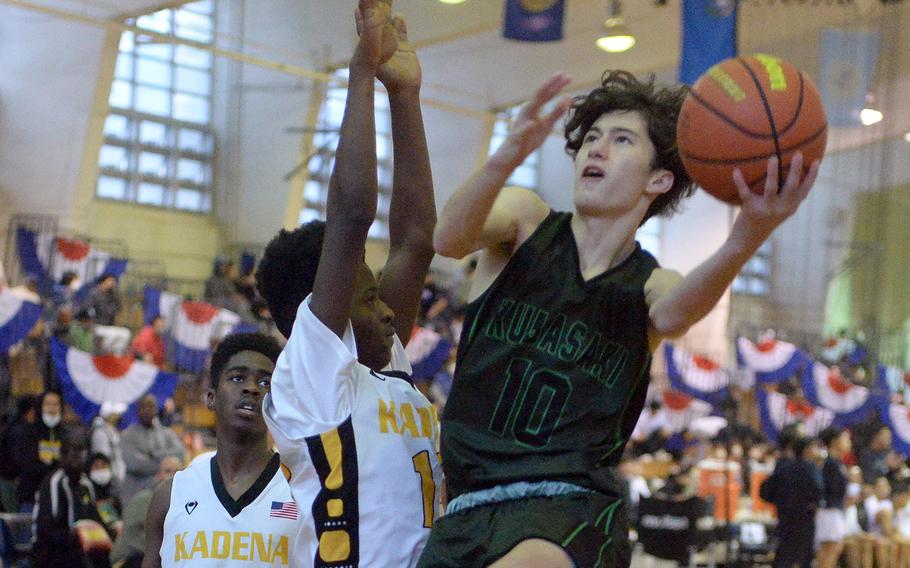 Kubasaki's Troy Harris skies for a shot against Kadena's defense in the third-place game, won by the Dragons 63-56.