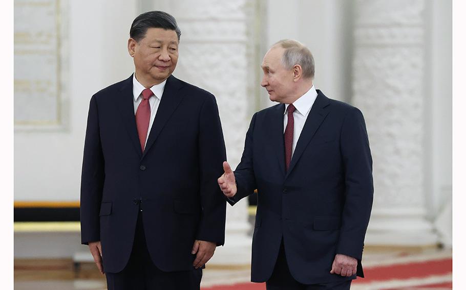 Russian President Vladimir Putin speaks to Chinese President Xi Jinping at The Grand Kremlin Palace, in Moscow, Russia, on March 21, 2023. 