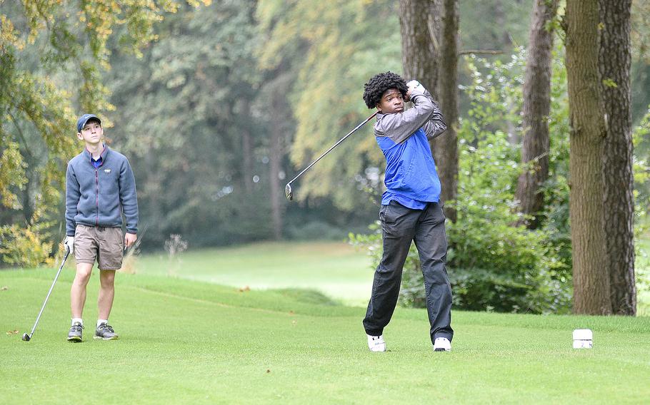 Ramstein's David Obermuller drives off the No. 2 tee during the first round of the DODEA European golf championships on Oct. 12, 2023, at Woodlawn Golf Course on Ramstein Air Base, Germany. Following in the backround is his Royal teammate Christian McHugh.