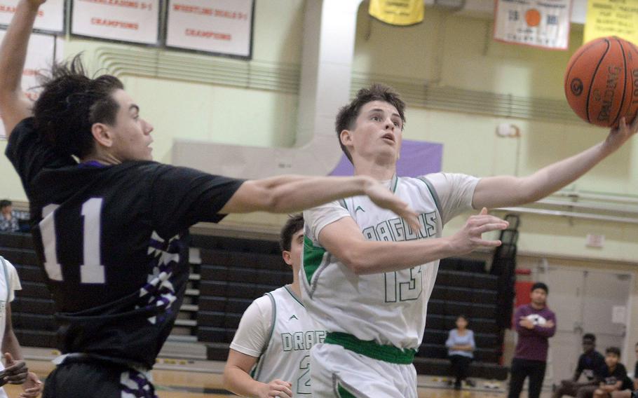 Kubasaki's Lucas Andrews drives against Zion's Giovanni Grubb during Tuesday's Okinawa boys basketball game. The Dragons won 86-42.