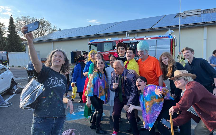 Cast and crew of “The SpongeBob Musical” dressed in costumes took selfies with a fire truck outside the theater venue at Kleber Kaserne in Kaiserslautern after sprinklers soaked the stage during dress rehearsals May 8, 2024. 
