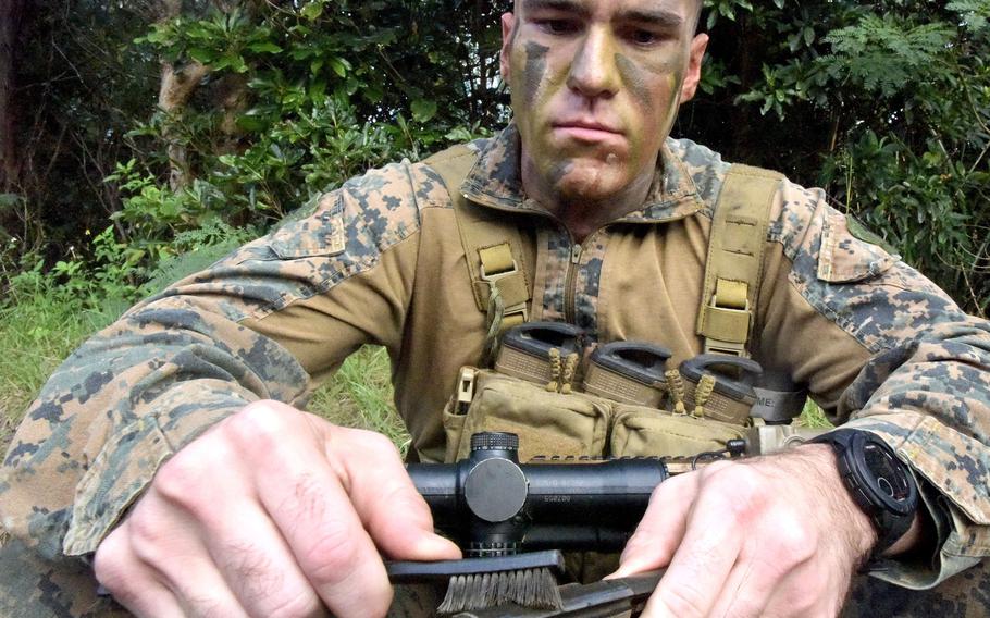 A Marine from Alpha Company, 1st Battalion, 2nd Marine Regiment out of Camp Lejeune, N.C., prepares for an exercise at the Central Training Area on Okinawa, Dec. 7, 2022.