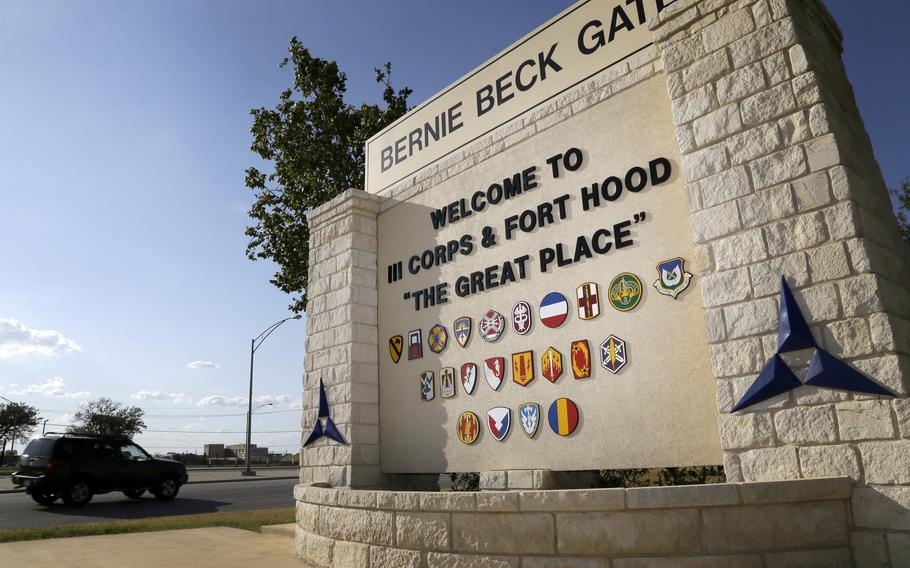 In this July 9, 2013, file photo, traffic flows through the main gate past a welcome sign in Fort Hood, Texas. 