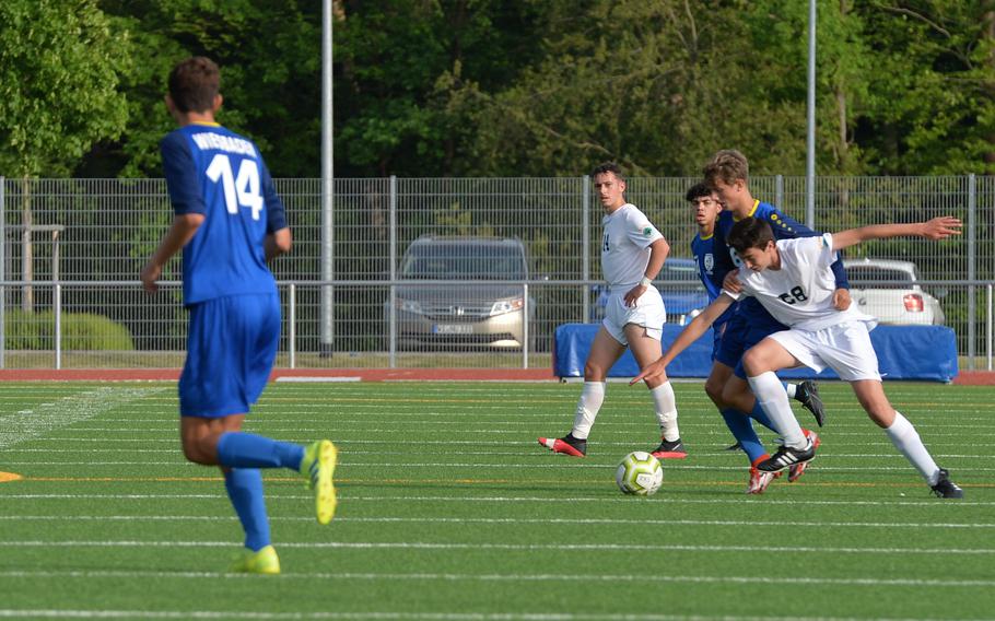 Wiesbaden Warrior Jacob Goodman gets a hold of SHAPE’s Jaime Munoz-Delgado Bernal during a fight for the ball at midfield during the DODEA-Europe Soccer Championships at Ramstein Air Base, Germany, May 16, 2022. Goodman received a yellow card for the foul play.