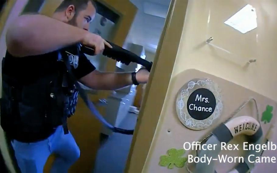 This image provided by Metropolitan Nashville Police Department shows bodycam footage of police responding to an active shooting at The Covenant School in Nashville, Tenn., on Monday, March 27, 2023. The former student who shot through the doors of the Christian elementary school and killed three children and three adults had drawn a detailed map of the school.