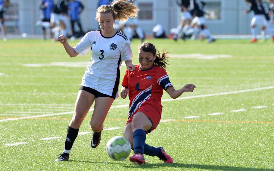 Lakenheath’s Natalie Manes clears the ball in front of Stuttgart’s Issa Sanchez in the girls Division I final at the DODEA-Europe soccer championships in Ramstein, Germany, May 18, 2023. Stuttgart beat Lakenheath 1-0 to win the title