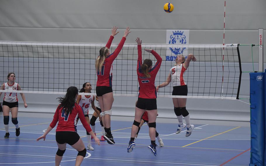 AOSR’s Clara Clayton spikes a ball towards Aviano’s Kayla Graney, left, and Mayci Salmon in the DODEA-Europe girls’ Division II championship match on Saturday Oct. 29, 2022, at Ramstein High School.