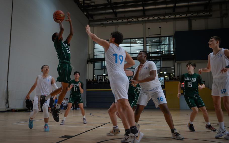 Naples’ Davion Bowie attempts takes aim for a two-pointer as Marymount’s Nicolo Arcangiolo attempts to block his shot during the DODEA-Europe Division II boys basketball tournament Wednesday, Feb. 15, 2023. Naples won 51-12.