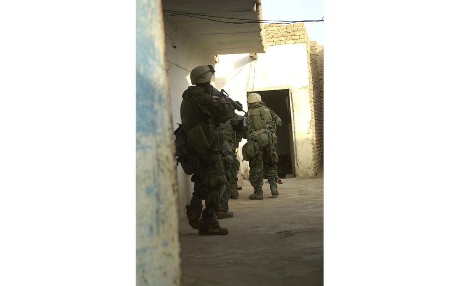 Marines cover one another’s movements through the tight confines of mud-brick huts during a raid in Al Fahr. Marines from Golf Company, 2nd Battalion, 23rd Marines netted weapons, intelligence and several Baath Party officials in the raid.   