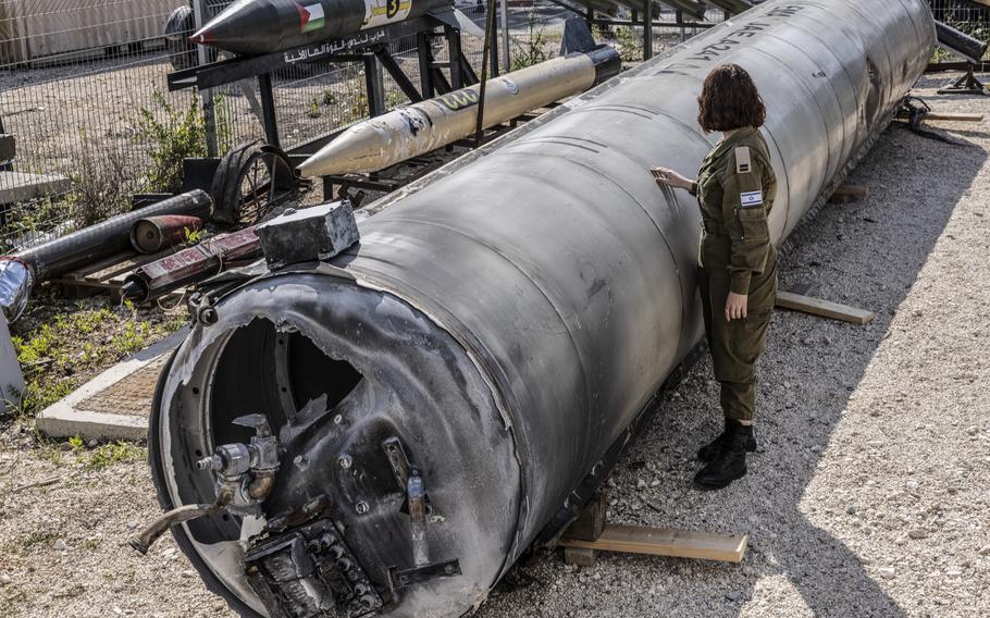 Israeli 1st Lt. Masha Michelson, left, with an Iranian ballistic missile that was intercepted in southern Israel.