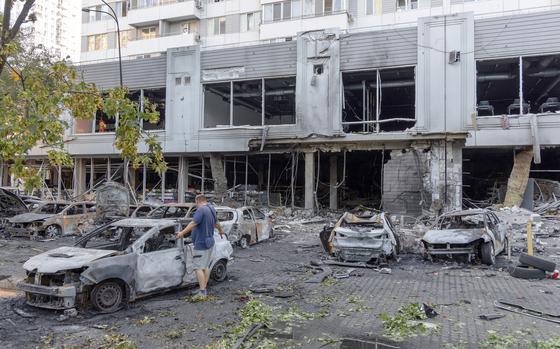 A man inspects a burnt-out car following a drone attack in Odesa on July 22, 2025, amid the Russian invasion in Ukraine. (Oleksandr Gimanov/AFP/Getty Images/TNS)