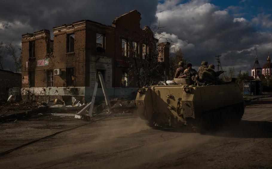 Ukrainian troops in an armored personnel carrier drive through the village of Shandryholove, near Lyman, Ukraine. The village sustained heavy damage in fighting that saw the Ukrainians retake control of Lyman, a key transport hub in the Donetsk region. 