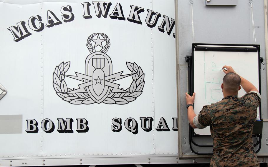 A Marine creates a range card in response to a simulated suspicious package during the annual Active Shield base-defense exercise at Marine Corps Air Station Iwakuni, Japan, Oct. 21, 2021.