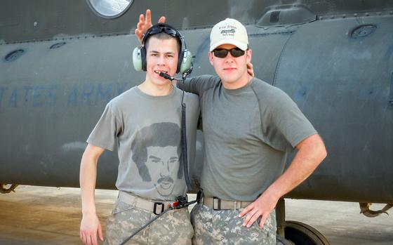 Sgt. Ryan Hoover and Sgt. Sean Hary, flight engineers with Company B, 2nd Battalion, 211th General Support Aviation Battalion, Iowa Army National Guard, pose for a photo at Camp Taji, Iraq, in 2011. During the company's deployment as part of Operation New Dawn, Hoover created the "All Night Long" logo and slogan for his unit, inspired by Lionel Richie's 1983 musical hit.