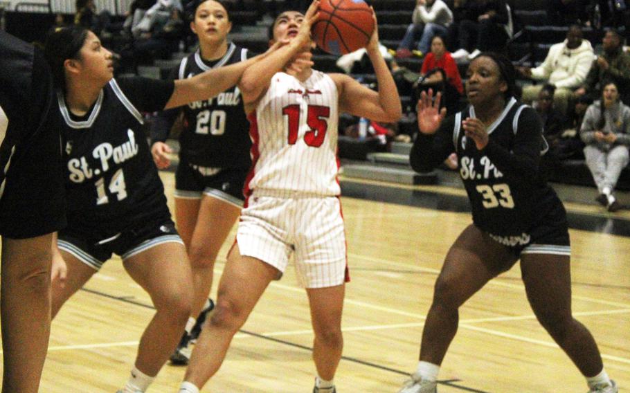 Kinnick's Leona Turner is surrounded by St. Paul defenders.