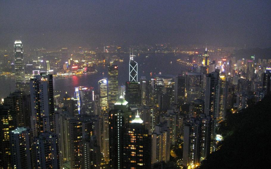 A night view of Victoria Peak in Hong Kong during a port visit by the nuclear-powered aircraft carrier USS Nimitz.