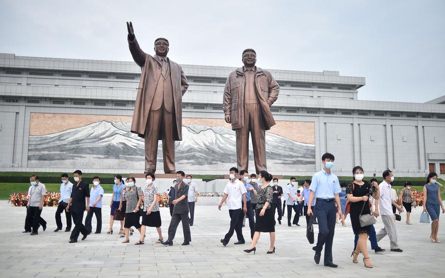 People visit the statues of the late North Korean leaders Kim Il Sung and Kim Jong Il, right, on Mansu Hill in Pyongyang on July 27, 2022, on the occasion of the 69th anniversary of the end of the Korean War.