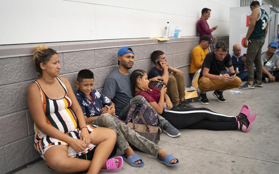 After leaving the Val Verde center, migrants wait at a gas station. Many boarded a greyhound bus to San Antonio, but these migrants did not have a plan or a place to sleep.