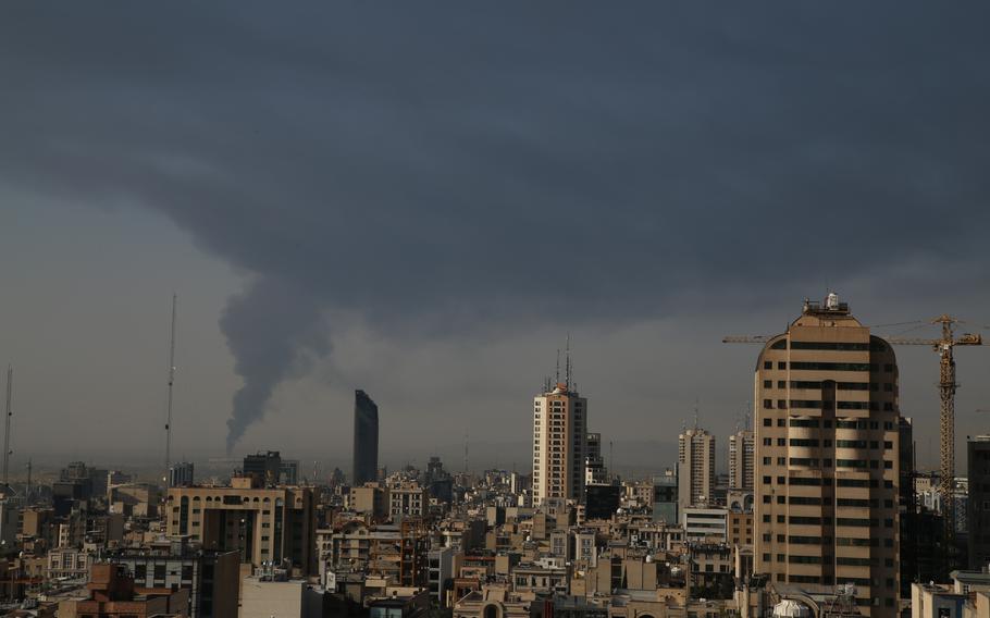 Smoke rises from a city line.