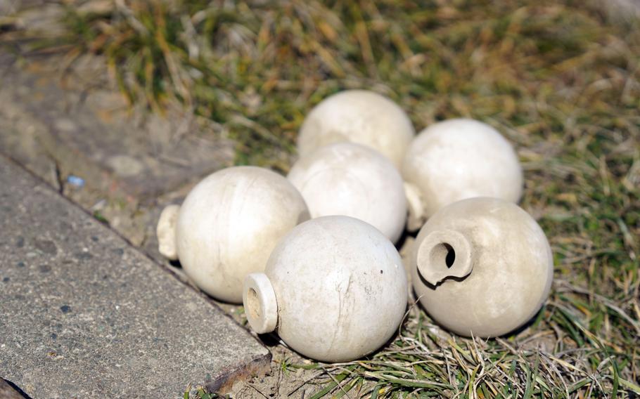 Late in World War II, with iron supplies running low, Japan’s military ordered potters to make grenades. Locals turned the old casings into flower holders and garden ornaments, according to Sadao Tokita, 83, who keeps half a dozen in his backyard.