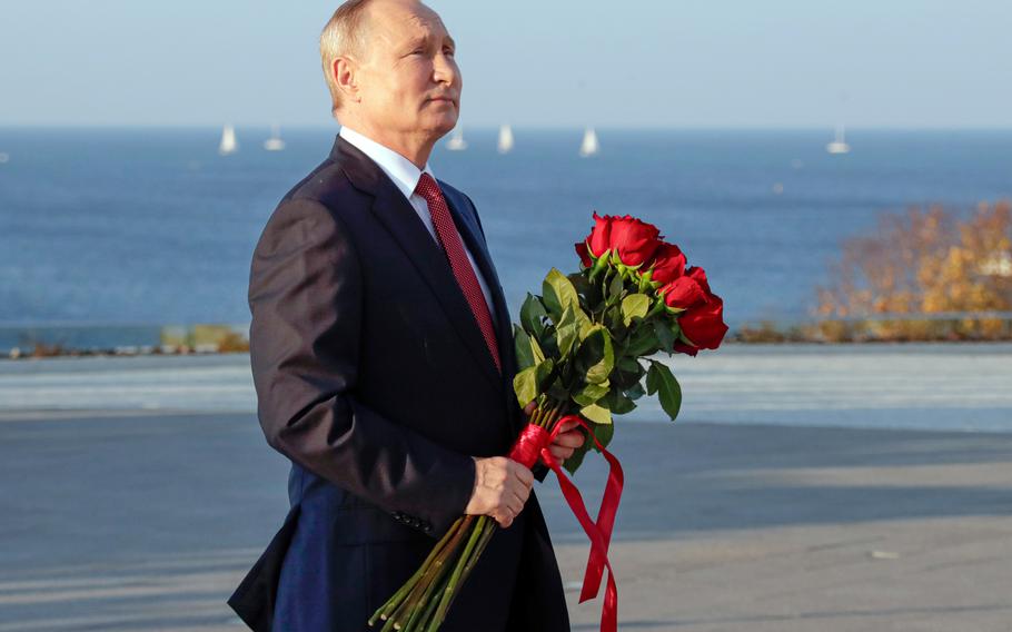 Russian President Vladimir Putin delivers attends a flower-laying ceremony at the memorial complex dedicated to the end of the Russian Civil War during marking Unity Day in Sevastopol, Crimea, Thursday, Nov. 4, 2021.